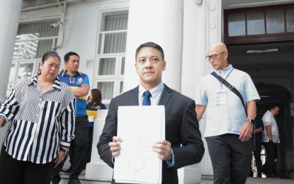 <p><strong>TAX EVASION CHARGES.</strong> Bureau of Internal Revenue Commissioner Romeo D. Lumagui Jr. shows a copy of the tax evasion charges filed against dismissed Bamban, Tarlac mayor Alice Guo and two others before the Department of Justice in Manila on Wednesday (Aug. 14, 2024). Revenue officials are auditing Guo’s business empire, which was uncovered during legislative inquiries in the Senate. <em>(PNA photo by Ben Pulta)</em></p>