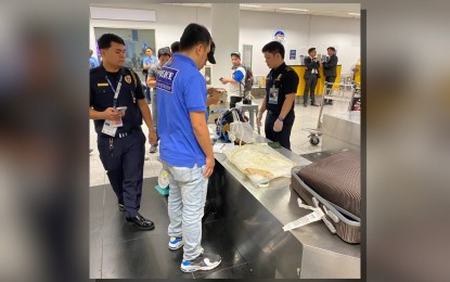 <p><strong>SEIZED.</strong> Members of the NAIA Interagency Drug Interdiction Task Group seize PHP35.8 million worth of suspected shabu at the airport's Terminal 3 on Tuesday night (Aug. 13, 2024). The contraband was seized from a 35-year-old female South African traveler. <em>(Photo courtesy of PDEG)</em></p>