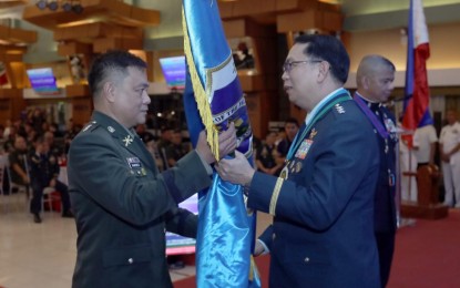 <p><strong>NEW CHIEF.</strong> Armed Forces of the Philippines vice chief of staff Lt. Gen. Arthur Cordura (right) hands over the command flag to Col. Ferdinand Geminic Ramirez who was appointed commander of the AFP Reserve Command during turnover ceremonies at Camp Aguinaldo in Quezon City on Wednesday (Aug. 14, 2024). Ramirez served as deputy commander of the unit before his appointment. <em>(Photo courtesy of the AFP)</em></p>