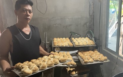 <p><strong>GOV’T AID</strong>. Roldan Capariño, 46, of Barangay Miisi, Daraga, Albay province shows his freshly baked bread at his bakery established out of the Department of Social Welfare and Development’s Sustainable Livelihood Program assistance of PHP20,000. He said he earns at least PHP40,000 per month<em>. (PNA photo by Connie Calipay)</em></p>