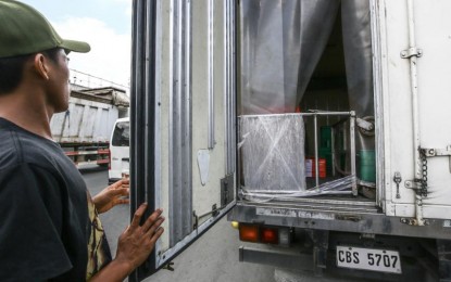 <div class="caption my-4">
<p><strong>STRINGENT.</strong> A driver opens his delivery truck for inspection by the Bureau of Animal Industry and Quezon City Veterinary Department at a checkpoint in Commonwealth Avenue on Tuesday (Aug. 20, 2024). Other checkpoints aimed to help prevent the spread of the African swine fever are set up in Kaingin Road, Balintawak; Mindanao Avenue-Tandang Sora Avenue intersection; and Barangay Paang Bundok in Amoranto Street, La Loma. <em>(PNA photo by Joan Bondoc)</em></p>
</div>