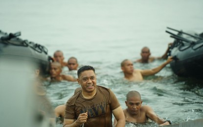 <p><strong>'HONORARY NAVY SEAL'.</strong> AFP chief Gen. Romeo Brawner Jr. joins the drills for the Navy Seals rites at Sangley Point, Cavite on Monday (Aug. 19, 2024). The specialized naval warfare drills include included rigorous warm-up exercises, boat paddling, swimming, one-mile run, and firing of .45-caliber pistol and sniper rifle. <em>(Photo courtesy of the AFP)</em></p>