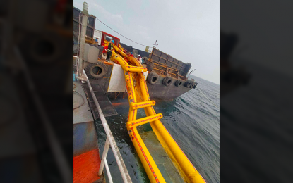 <p><strong>OIL RECOVERY.</strong> The Harbor Star, the contracted salvor for MT Terranova, deploys the Current Buster 4 oil recovery system to augment oil clean-up and containment surrounding the sunken oil tanker on Wednesday (Aug. 21, 2024). About 42,000 liters of oil were siphoned from Terranova through an additional booster pump, increasing oil siphoning efficiency. <em>(Photo courtesy of PCG)</em></p>