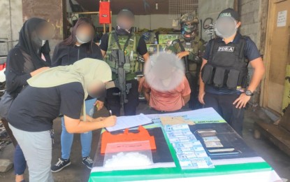 <p><strong>ENTRAPMENT.</strong> An anti-narcotic agent documents the illegal drug seized from a suspect during a buy-bust operation in Malabang, Lanao del Sur, on Wednesday (Aug. 21, 2024). The suspect (center, handcuffed) yielded PHP3.4 million worth of shabu. <em>(Photo from PDEA-BARMM)</em></p>