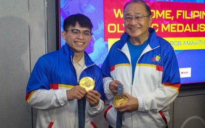 <p><strong>MORE INCENTIVES.</strong> Paris Olympics champion Carlos Yulo shows his two gold medals to MVP Sports Foundation chairman emeritus Manny Pangilinan during a courtesy call in which Yulo received PHP10 million from the MVPSF on Thursday (Aug. 22, 2024). Pangilinan said MVPSF will continue to support Filipino athletes in the Los Angeles Olympics Games in 2028. <em>(contributed photo)</em></p>