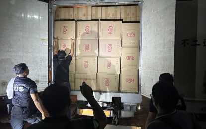 <p><strong>WAREHOUSE RAID.</strong> Customs officers inspect a truck containing smuggled cigarettes worth PHP500 million during a raid in one of the warehouses inside a compound in Meycauayan City, Bulacan on Thursday (Aug. 22, 2024). The BOC on Friday said the raids in 19 warehouses also yielded PHP5 billion worth of counterfeit items. <em>(Photo courtesy of BOC)</em></p>