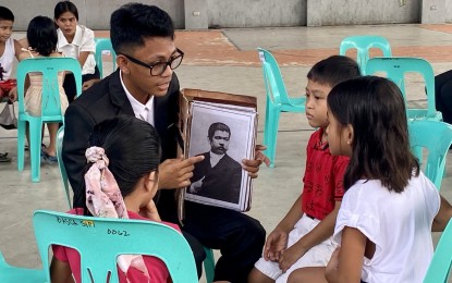 <p><strong>HEROES' DAY.</strong> A member of the Junior Chamber International-Daraga discusses the life and works of Marcelo H. Del Pilar with learners as part of the celebration of National Heroes' Day in Barangay Sipi, Daraga, Albay on Saturday (Aug. 24, 2024). More than 35 Grade 3 and Grade 4 learners attended the activity<em>. (PNA photo by Connie Calipay)</em></p>