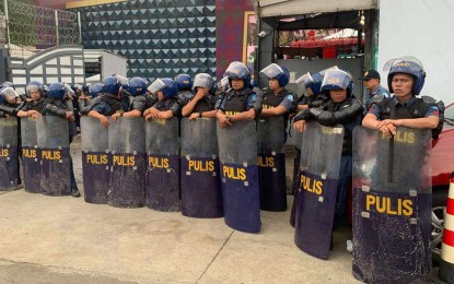 <p>Davao Region cops deployed outside the Kingdom of Jesus Christ compound in Davao City on Saturday (Aug. 24, 2024)<em>. (PNA photo by Robinson Niñal Jr.)</em></p>