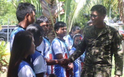 <p><strong>PEACE EFFORTS</strong>. Brig. Gen. Noel Vestuir, commander of the Army’s 802nd Infantry Brigade, shakes hand with former rebels during a reunion on Sunday (Aug. 25, 2024). The Philippine Army is largely counting on the participation of former rebels for the surrender of the remaining 26 active members of the New People’s Army hiding in the mountains of Leyte Island. <em>(Photo courtesy of Philippine Army) </em></p>