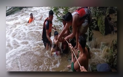 <p><strong>CLOSED</strong>. Stranded visitors at Avis Falls in Tanap, Burgos, Ilocos Norte are being rescued after a flashflood late Monday afternoon (Aug. 26, 2024). Due to unpredictable weather, the local government unit temporarily closed this outdoor attraction until further notice. <em>(Photo courtesy of BFP)</em></p>