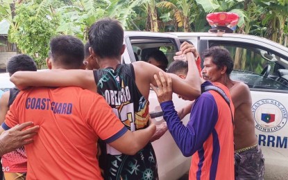 <p><strong>RESCUED.</strong> Locals and personnel of the Philippine Coast Guard (PCG) assist one of the survivors of the two motorbancas that capsized in the waters off Caluya Island, Antique on Monday (Aug. 26, 2024). The PCG has brought home the 10 survivors of the capsized bancas and continues its search for seven missing passengers. <em>(Photo courtesy of PCG)</em></p>