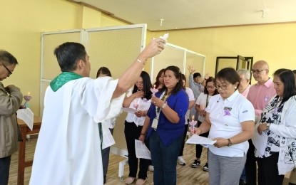 <p><strong>CANCER TESTING CLINIC</strong>. A Catholic priest on Thursday (Aug. 29, 2024) prays over the medical workers assigned at the newly opened Baguio City Health Services Office’s Blood and Cancer clinic. The clinic will provide screening service to patients referred by the 16 District Health Centers serving the city’s 128 villages. <em>(PNA photo by Liza T. Agoot)</em></p>