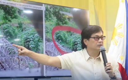 <p><strong>DIFFICULT SEARCH.</strong> Interior Secretary Benjamin Abalos Jr. shows photos of barbed wires and other secret passageways discovered by police officers inside the Kingdom of Jesus Christ compound in Davao City, during a press briefing in Camp Crame on Thursday (Aug. 29, 2024). Abalos said they are coordinating with the City Engineer's Office to determine whether these passageways were indicated in the construction plan of the group's compound.<em> (Photo courtesy of DILG)</em></p>