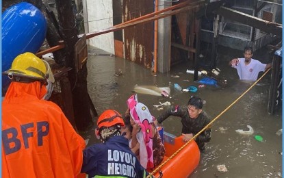 <p><strong>READY TO RESPOND.</strong> Rescuers of the Armed Forces of the Philippines (AFP) and Bureau of Fire Protection help evacuate residents amid floods in Barangay Loyola Heights, Quezon City on Monday (Sept. 2, 2024). The AFP has put on standby 11 search, rescue, and retrieval teams to assist those affected by the impact of Tropical Storm Enteng and the enhanced southwest monsoon. <em>(Photo courtesy of the AFP)</em></p>