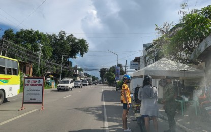 <p><strong>CHECKPOINT</strong>. A police officer checks motorist credentials at a checkpoint in this undated photo. The National Police Commission in Negros Oriental is enhancing the Community Service-Oriented Policing Program in various towns and cities to address criminality. <em>(PNA file photo by Mary Judaline Partlow)</em></p>