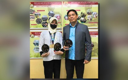 <p><strong>ACHIEVER</strong>. Mahmooda Aziza Bhatti, 23, shows off her medals and plaques to Gerald Hilario, dean of the Bulacan State University Sarmiento Campus, after bagging the prestigious gold medal in the Life Science category at the World Youth STEM Invention Innovation 2024 in Kuala Lumpur, Malaysia. Aside from clinching the coveted award, she also took home the Platinum Award for Best Project (college category), Semi Grand Award (research sponsorship), and Best Innovation Award in the competition held in July 2024<em>. (Photo courtesy of Mahmooda Aziza Bhatti) </em></p>