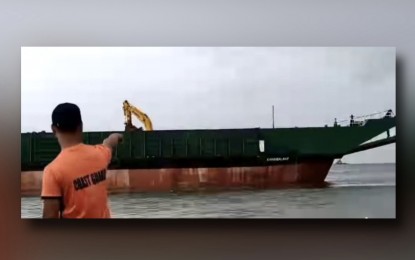 <p><strong>AGROUND.</strong> A barge (Karangalan 2) runs aground off Navotas City on Tuesday (Sept. 3, 2024) due to Tropical Storm Enteng. The PCG said its forward ropes accidentally broke, causing it to be adrift at around 6 a.m. <em>(Screenshot from PCG video)</em></p>