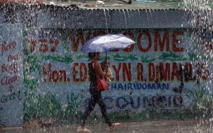 <p><strong>MONSOON RAINS.</strong> A woman walks in the rain along Quirino Highway in Malate, Manila on Thursday (Sept. 5, 2024). The weather bureau said scattered rains caused by the southwest monsoon are expected in Metro Manila on Friday (Sept. 6, 2024). <em>(PNA photo by Yancy Lim)</em></p>