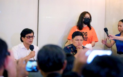 <p><strong>BACK IN PH.</strong> Dismissed Bamban, Tarlac mayor Alice Guo (in orange shirt) is presented to the press after arriving on a chartered plane at the Royal Star Aviation hangar in Pasay City at about 1:30 a.m. on Friday (Sept. 6, 2024). Guo concealed her handcuffs under a white jacket, refused to take off her mask, spoke briefly, and turned her back to the media when the press conference began. <em>(PNA photo by Avito C. Dalan)</em></p>