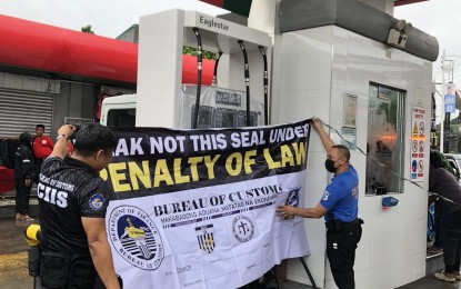 <p><strong>SEALED.</strong> Customs officers seal a gas station in Valenzuela City on Thursday (Sept. 5, 2024). The BOC on Friday (Sept. 6) said three of the gas station's four tanks failed the fuel mark test after these were found to contain PHP3.1 million worth of unmarked fuel.<em> (Photo courtesy of BOC)</em></p>