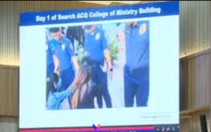 <p><strong>FRISKED.</strong> A video of a female cop being frisked by Kingdom of Jesus Christ members, is shown during the Senate public hearing in Davao City on Friday (Sept. 6, 2024). Philippine National Police-Davao Region Director Brig. Gen. Nicolas Torre III said they had to endure such humiliation to start their search for Pastor Apollo Quiboloy. <em>(Screengrab from Senate livestream)</em></p>