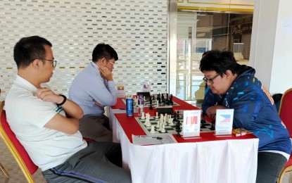 <p><strong>CHAMPION.</strong> Filipino National Master Marlon Bernardino Jr. (right) plays against Chinese Feng Wenzhe in the first round of the 3rd Laos International Chess Open Championship in Vientiane City on Sept. 1, 2024. Bernardino won the match and eventually ruled the nine-round tournament. <em>(Contributed photo)</em></p>