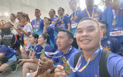 <p><strong>RUN FOR WPS. </strong> Coast Guard Seaman First Class Arnold Merin shows his finisher medal along with other runners at the "Takbo para sa WPS" on Sunday (Sept. 8, 2024). Merin, who hailed from Surigao del Norte, finished the 16-kilometer category. <em>(Photo courtesy of CGSN1 Merin)</em></p>