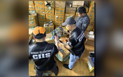 <p><strong>WAREHOUSE RAID.</strong> Customs officers check smuggled items discovered inside a warehouse during a raid in Binondo, Manila on Sept. 6, 2024. The BOC on Monday (Sept. 9) said the raid yielded PHP4.8 billion worth of smuggled vapes and counterfeit goods. <em>(Photo courtesy of BOC)</em></p>