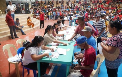 <p><strong>GOV'T AID</strong>. Low-income residents in Burgos, Ilocos Norte receive Ayuda Para sa Kapos ang Kita Program payout on Aug. 16, 2024. Beneficiaries include solo parents, fisherfolk, and vendor. <em>(Photo courtesy of Ilocos Norte 1st Congressional District Office)</em></p>