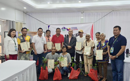 <p><strong>LAND PATENTS.</strong> Department of Environment and Natural Resources (DENR) officials distribute land titles to residents of Barangay Baloganon, Masinloc, Zambales in this photo taken on Sept. 5, 2024. The DENR on Tuesday (Sept. 10) said it further speed up the processing and issuance of public land patents to eligible beneficiaries nationwide under its “Handog Titulo” program. <em>(Photo courtesy of DENR)</em></p>