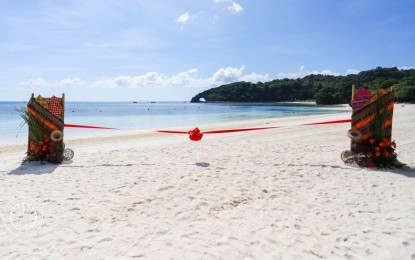 <p><strong>FOR MUSLIM TRAVELERS.</strong> The Marhaba Boracay, with the keyhole-shaped Lapus-Lapus rock formation as its backdrop. The cove was patterned from other existing Muslim-friendly beaches in tourism destinations such as the Maldives and Thailand.<em> (Photo courtesy of DOT)</em></p>