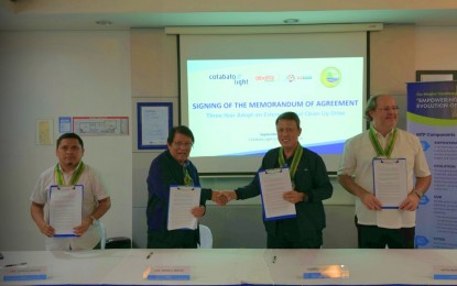 <p><strong>ENVIRONMENTAL PROTECTION. </strong>BARMM Environment Minister Akmad Brahim (2nd from left) and Cotabato Light president and COO Valentin Saludes III (3rd from left) shake hands after signing a memorandum of agreement for a three-year environmental clean-up initiative in Cotabato City on Wednesday (Sept. 11, 2024). The partnership focuses on pollution-affected areas in the Bangsamoro region. <em>(Photo courtesy of MENRE-BARMM)</em></p>