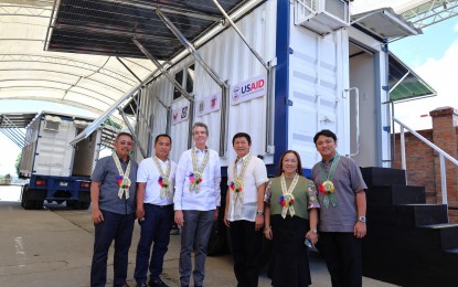 <p><strong>DONATION.</strong> USAID Mission Director Washburn (3rd from left) hands over mobile energy systems to Philippine Department of Energy Assistant Secretary Mario Marasigan (left) and Lal-lo Mayor Florante Pascual (3rd from right) and Santa Ana Mayor Nelson Robinion (2nd from left). The US, through USAID, donated PHP11.6 million worth of mobile storage units and mobile energy systems to help strengthen Cagayan province’s disaster risk reduction capacity. <em>(Photo courtesy of the US Embassy in Manila)</em></p>