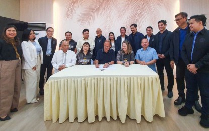 <p><strong>BOOSTING LOCAL EMPLOYMENT.</strong> Marikina City Mayor Marcelino Teodoro (middle, wearing blue polo) signs Resolution No. 127, Series of 2024, on Wednesday (Sept. 11, 2024) officially approving the development of "Armscor Global Defense Inc." as the "Armscor Manufacturing Special Economic Zone". The measure is seen to help boost employment opportunities for residents. <em>(Photo courtesy of Marikina LGU)</em></p>