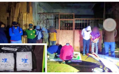 <p><strong>BUSTED.</strong> Anti-narcotics agents account for the illegal drugs seized from four suspects (in hoodie jackets and handcuffs), including a policeman, during an anti-drug operation in Barangay San Raymundo, Jolo, Sulu, on Thursday night (Sept. 12, 2024). Seized from the group (inset) were P13.6 million worth of shabu.<em> (Photo courtesy of PDEA-BARMM)</em></p>