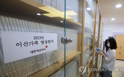 <p><strong>SEPARATED FAMILY MEMBERS</strong>. This file photo, taken Sept. 8, 2022, shows an official at the Korean Red Cross checking a collection of video messages by South Korean families separated by the 1950-53 Korean War. The video letters were produced for delivery to the separated families' kin in North Korea. <em>(Yonhap)</em></p>