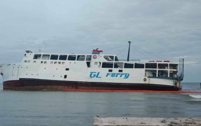 <p><strong>GROUNDED.</strong> The passenger vessel GL Ferry is stuck in a shallow and sandy portion of the Lazi Port in Lazi, Siquijor, with oil spill containment booms around it. It was battered by huge waves and strong winds on Friday (Sept. 13, 2024) and was pushed toward another portion of the port. <em>(Photo courtesy of Coast Guard Station-Siquijor)</em></p>