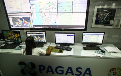 <div class="caption my-4">
<p><strong>MONITORING.</strong> Jane Bornillo, Weather Observer 1 of the Philippine Atmospheric, Geophysical and Astronomical Services Administration, checks on Metro Manila river systems at the state bureau's headquarters in Quezon City on Monday (Sept. 16, 2024). Tropical Depression Gener slightly weakened and might exit the Philippine Area of Responsibility between Tuesday and Wednesday (Sept. 17 and 18). <em>(PNA photo by Joan Bondoc)</em></p>
</div>