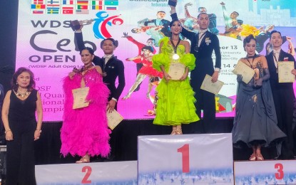 <p><strong>DANCESPORT.</strong> Jung Hoon and Lee Yee-un of South Korea (center) won the Standard Adult category in the World DanceSport Federation (WDSF) Cebu Open 2024 at the Waterfront Cebu City Hotel and Casino in Lahug on Sunday (Sept. 15, 2024). Philippine DanceSport Federation, Inc. (PDSF) president Becky Garcia (foreground) awarded the trophies, medals and certificates to the Top 3 finishers. <em>(PNA photo by Jean Malanum)</em></p>