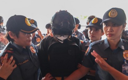 <p><strong>WITNESS.</strong> Philippine National Police officers escort dismissed Bamban, Tarlac mayor Alice Guo for her appearance at the Senate hearing on illegal Philippine Offshore Gaming Operators in Pasay City on Tuesday (Sept. 17, 2024). Guo maintained she has no links with the illegal gaming industry. (<em>Photo courtesy of Senate PRIB)</em></p>