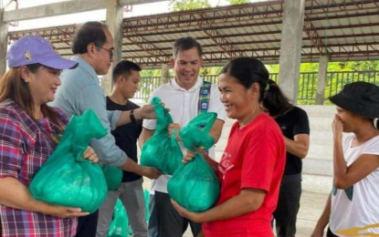 <p><strong>WASHED OUT.</strong> Antique Rep. Antonio Agapito Legarda (fourth from left) on Wednesday (Sept. 18, 2024) extends relief assistance to families from the Municipality of Laua-an whose houses were washed out when the Paliwan River overflowed on Tuesday (Sept. 17). The families are temporarily resettled in the National Housing Authority (NHA) relocation site in Barangay Guinbanga-an. <em>(Photo courtesy of Dr. Nene Maye Plameras)</em></p>