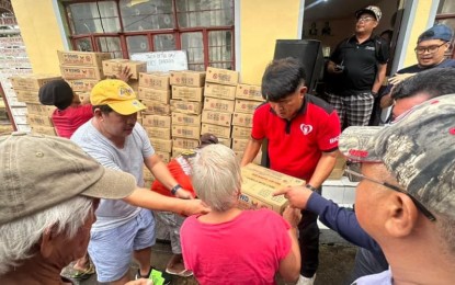 <p><strong>FAMILY FOOD</strong> <strong>PACKS</strong>. Families affected by weather disturbances in Bacolod and San Vicente villages in Bato, Camarines Sur receive assistance from Department of Social Welfare and Development (DSWD)-Bicol Regional Director Norman Laurio (in red shirt) on Tuesday (Sept. 17, 2024). The agency has PHP220 million worth of assistance ready for distribution<em>. (Photo courtesy of DSWD-Bicol) </em></p>