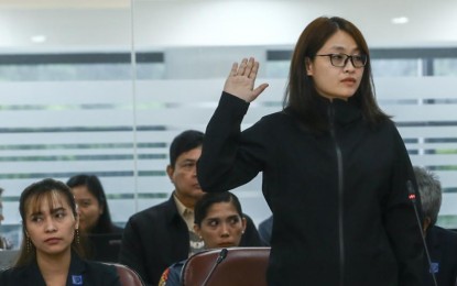 <p><strong>THE WHOLE TRUTH.</strong> Former mayor Alice Guo is placed under oath before the start of the House of Representatives quad committee hearing on illegal Philippine Offshore Gaming Operators at the Batasang Pambansa, Quezon City on Thursday (Sept. 19, 2024). She will be transferred to Camp Crame in Quezon City to the Pasig City Jail on Monday (Sept. 23). <em>(PNA photo by Joan Bondoc)</em></p>