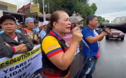 <p><strong>PROTEST WITHOUT PERMIT</strong>. Kabakod-Knetco president Lilian Sembrano (left) and Bacod-Manibela president Rudy Catedral lead the protest without a permit outside a hotel along Lacson St. in Bacolod City on Wednesday (Sept. 18, 2024). They posted bail after the Bacolod City Police Office charged them for disobedience to an agent of a person in authority before the City Prosecutor's Office on Wednesday night. <em>(Contributed Photo)</em></p>