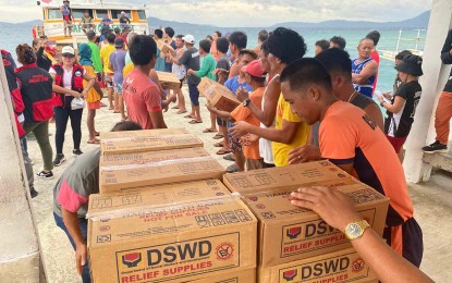 <p><strong>TIMELY AID.</strong> Around 600 families in three barangays of Dinagat town in Dinagat Islands province get aid from the Department of Social Welfare and Development in the Caraga Region on Wednesday (Sept. 18, 2024). The distribution followed the effects of the enhanced southwest monsoon caused by Tropical Storm Bebinca.<em> (Photo courtesy of DSWD-13)</em></p>