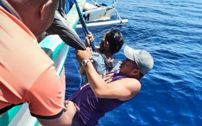 <p><strong>RESCUED.</strong> Philippine Coast Guard members in Batanes rescue fisher Robin Dejillo off the waters of Basco on Thursday (Sept. 19, 2024). He was reported missing on Aug. 4 and survived by drinking rainwater and eating fish.<em> (Photo courtesy of PCG)</em></p>