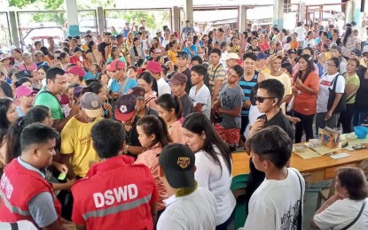 <p><strong>FOOD ASSISTANCE</strong>. Residents of Camarines Sur province affected by weather disturbances fall in line to receive family food packs from the Department of Social Welfare and Development (DSWD)-Bicol on Thursday (Sept. 19, 2024). More than 200,000 food packs worth PHP147 million were already distributed across the region as of Sept. 20.<em> (Photo courtesy of DSWD-Bicol) </em></p>