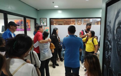 <p><strong>HOME AT LAST</strong>. Former Iloilo City mayor Jed Patrick Mabilog (in red) receives a warm welcome during his visit to the Iloilo City Hall on Friday (Sept. 20, 2024). In a press conference, he said he is confident he will be given justice under the administration of President Ferdinand R. Marcos Jr.<em> (PNA photo by PG Lena)</em></p>