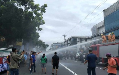 <p><strong>DISPERSAL.</strong> Police civil disturbance management personnel and firefighters in Bacolod City disperse the demonstrators who turned violent during a rally in front of a hotel in Bacolod City on Wednesday (Sept. 18, 2024). The Bacolod City Police Office reiterated the enforcement of Batas Pambansa Blg. 880 or the Public Assembly Act of 1985 to ensure public order and safety during mass gatherings and demonstrations. <em>(Photo courtesy of Cheng Santillan)</em></p>