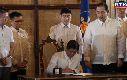 <p><strong>SEAFARERS LAW.</strong> President Ferdinand R. Marcos Jr. signs Republic Act No. 12021 or An Act Providing for the Magna Carta of Filipino Seafarers in a ceremony in Malacañang on Monday (Sept. 23, 2024). The new law aims to protect the rights and overall welfare of domestic and overseas Filipino seafarers, as well as promote their full employment. <em>(RTVM Screengrab)</em></p>